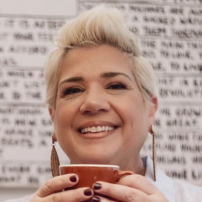 Anna Wieczorek smiling, holding a coffee cup